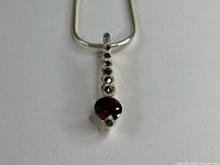 Close-up of pendant showing garnet and marcasite details