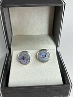 Front view of both round sterling silver earrings in display box