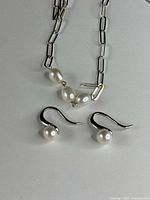 Necklace and earrings together showing design and pearl color
