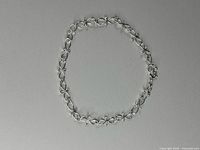 Full view of bracelet laid flat showing complete link pattern and clasp