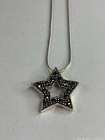 Star pendant on snake chain close-up
