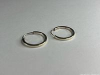 both hoop earrings lying flat showing size and shape