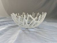 Side view of white fused glass coral design bowl