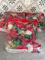 Three sealed bags of assorted metallic gift bows