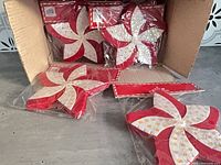 Box of individually wrapped red felt star decorations