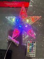 Star topper illuminated with multi-colour LEDs, wired lead and remote visible