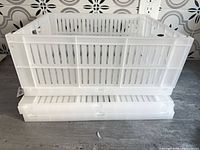 Three white collapsible plastic crates stacked, sides vented