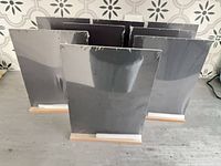 Front view of eight packaged chalkboards on bases showing chalk sticks