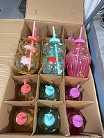 Open case showing all 15 tumblers segregated in cardboard compartments