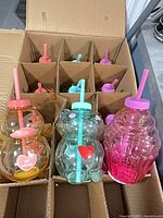 Open shipping box showing all 15 novelty tumblers sorted in partitions