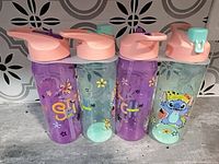 Front view showing all four tumblers, colours, graphics and lids