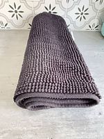 Bath mat rolled showing texture and thickness