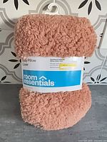 Front of packaged Room Essentials body pillow cover showing branding and texture