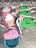 Overview of six novelty bags: three frog, two ice-cream, one cupcake