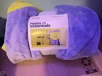 Rolled blanket with Room Essentials label showing color and texture