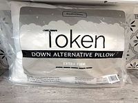 Front view of packaged Token down alternative extra firm pillow