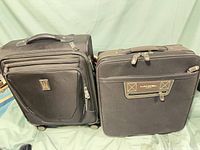 Front view of both suitcases showing branding, handles and zip compartments