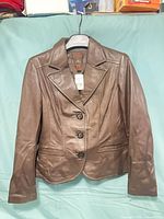 Front view of Danier brown leather blazer on hanger