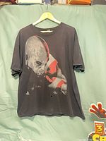 Full front view of T-shirt on hanger