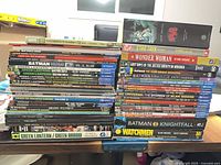 Full view of two stacks of softcover graphic novels