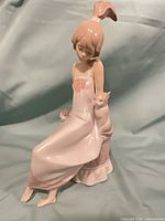 Front view of Lladro figurine showing girl, cats, and color details