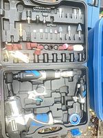 Open Mastercraft air tool kit showing impact wrench, air ratchet, die grinder and assorted accessories arranged in molded case