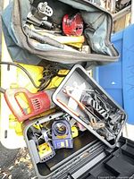 Overview of lot: bag, jigsaw, tape measures in case, yellow case