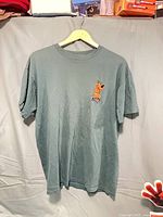 Front view of muted green T-shirt showing Scooby-Doo chest graphic