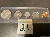 Obverse view of five 1963 coins in Whitman holder