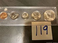 Front view of five-coin 1967 mint set in holder