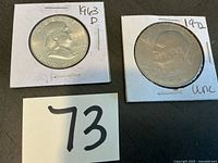 Obverse of 1963-D Franklin half and 1972 Eisenhower dollar in cardboard flips