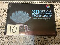 Front of sealed box showing lotus flower illusion graphic and product name