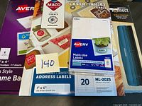 Stack of unopened Avery, Maco label packs and Bostitch rail