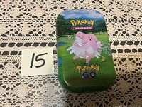 Closed Pokémon GO mini tin showing Blissey artwork and lot number card