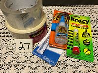 Overall lot showing two Scotch tape rolls, Gorilla Super Glue, Krazy Glue, and white super glue tube