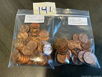 Two bags of uncirculated Denver-mint Lincoln cents, years 1960 and 1961