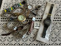 All watches spread on lace surface, Sharp packaged watch visible
