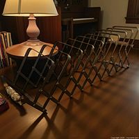 Rack fully expanded on tabletop beside lamp