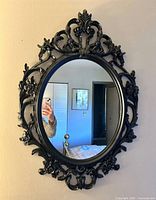 Front view of mirror showing frame details and oval glass