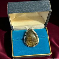 Ring in presentation box showing teardrop labradorite stone and bezel setting