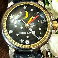 Watch face close-up showing dial design, bezel, hands, date window