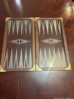 Board fully opened showing etched glass playing field and brass corners