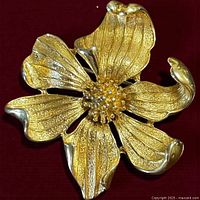 Front view of gold-tone pansy brooch showing petal detail and centre cluster