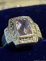 Close-up of sterling silver ring showing amethyst center and surrounding clear stones