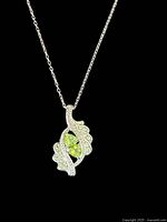 Close view of pendant showing peridot and swirl design