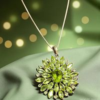 Close-up of sunburst pendant showing peridot stones and 925 silver setting