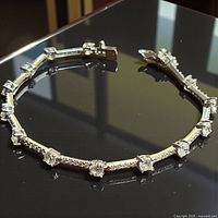 Full view of bracelet on dark surface showing design and clasp