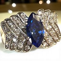 Front view of sterling silver ring with marquise sapphire and pavé shoulders