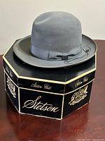 Grey felt Stetson fedora on top of its octagonal box