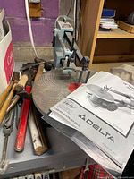 Scroll saw with manual and hand tools on table